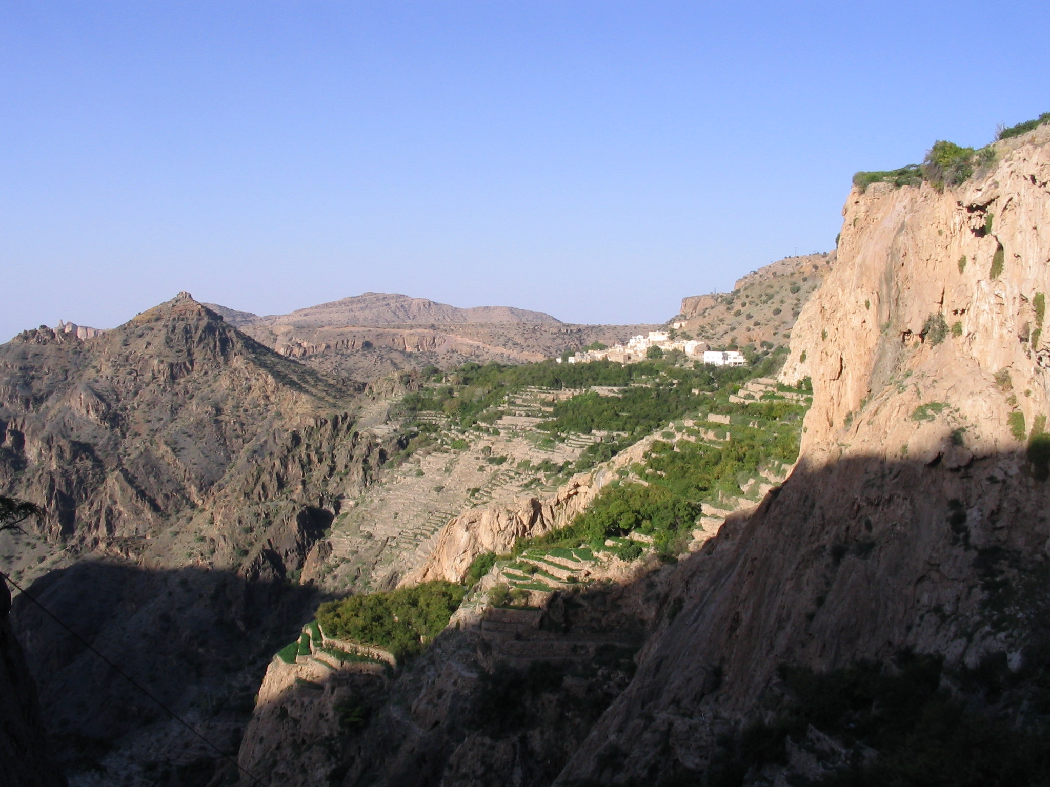 Terraced oasis fields at Ash Sharayjah. The pomegranates and other temperate tree crops there are already enjoying the morning sun. Trees in the oasis of Qasha’, located in the lower left corner of the image, are still hidden in the shadows.